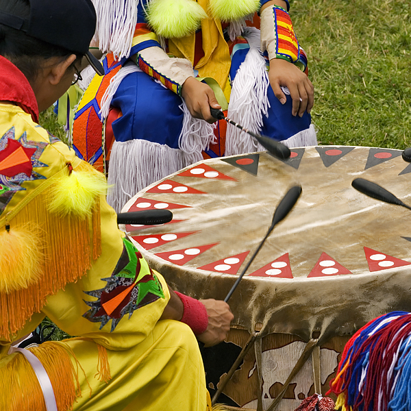 A Native American community playing drums at a powwow