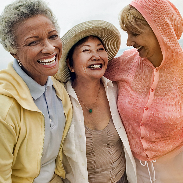 Three mature women laughing together