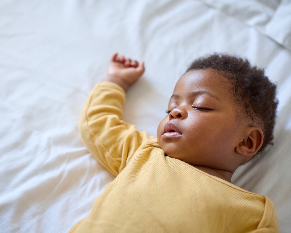 Infant girl lying on back.