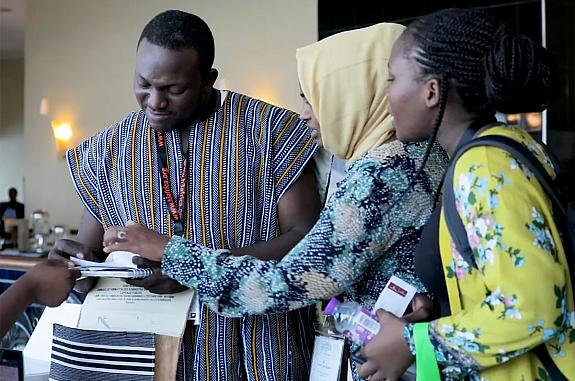 Three participants in the H3Africa program talking to each other