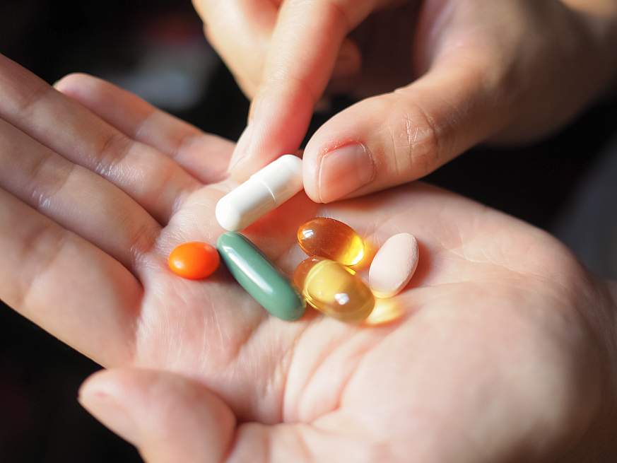 Image of multivitamins in a person’s hand