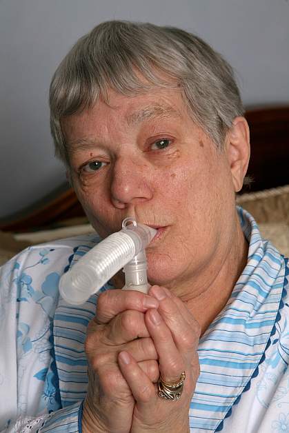 Photo of an older woman using a nebulizer