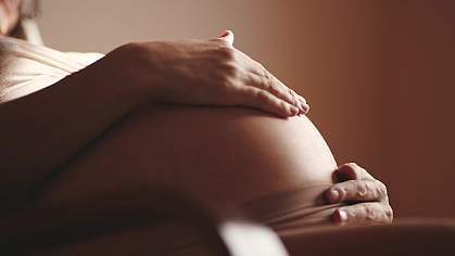 Close-up belly of a pregnant woman.