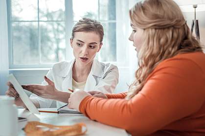  Teen with obesity speaking with a medical professional.