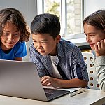 Three kids looking at a laptop