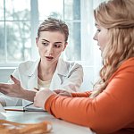  Teen with obesity speaking with a medical professional.